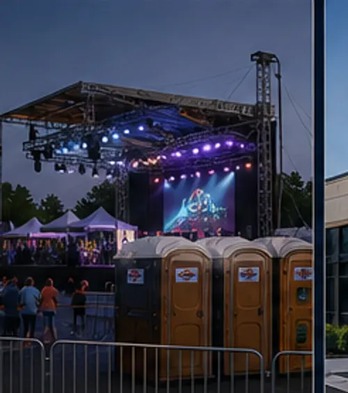 Outdoor event stage with portable restrooms