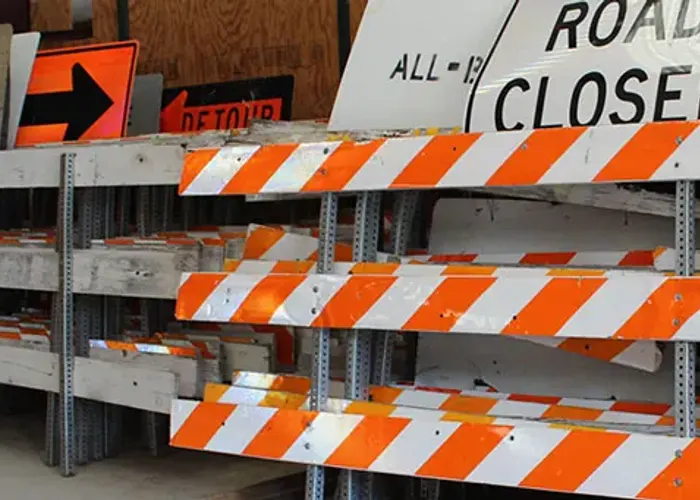 Rack of All-Brite barricades and detour signs ready for rental