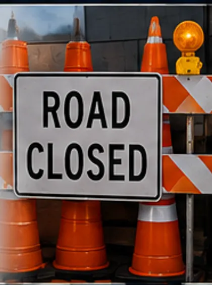 Road closed sign with traffic cones