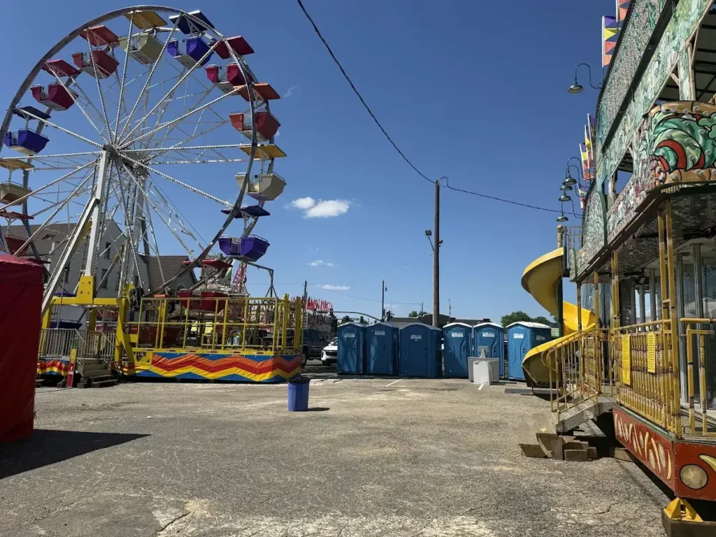 Portable toilets positioned along a carnival midway