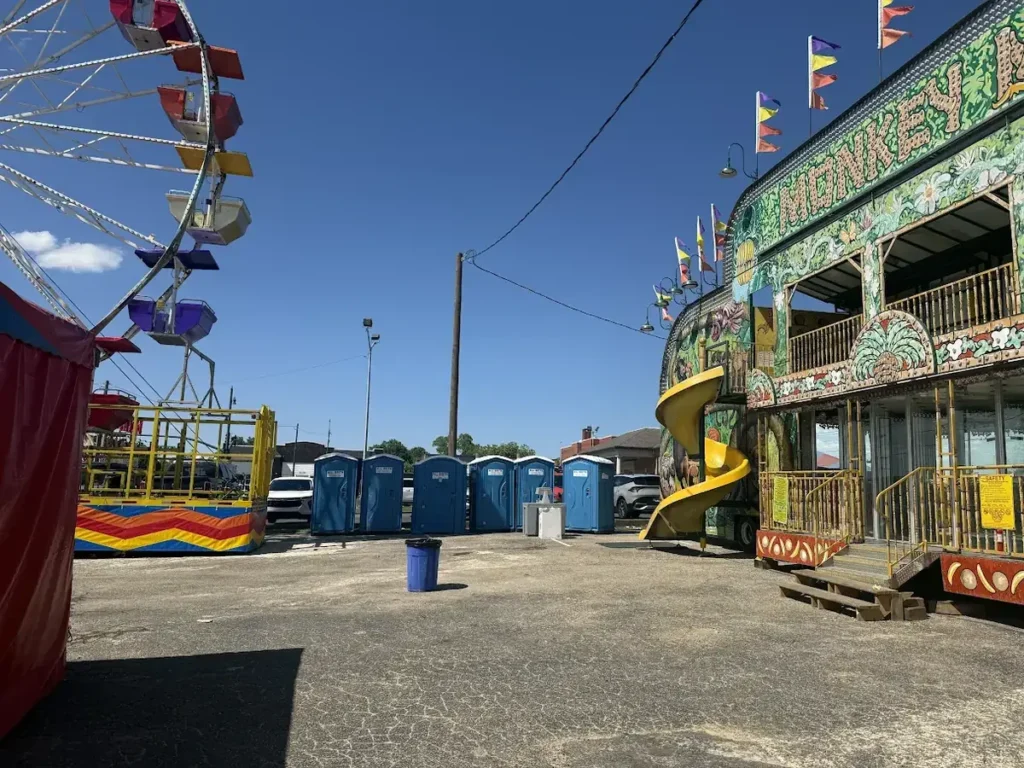 Portable toilets next to fairground rides