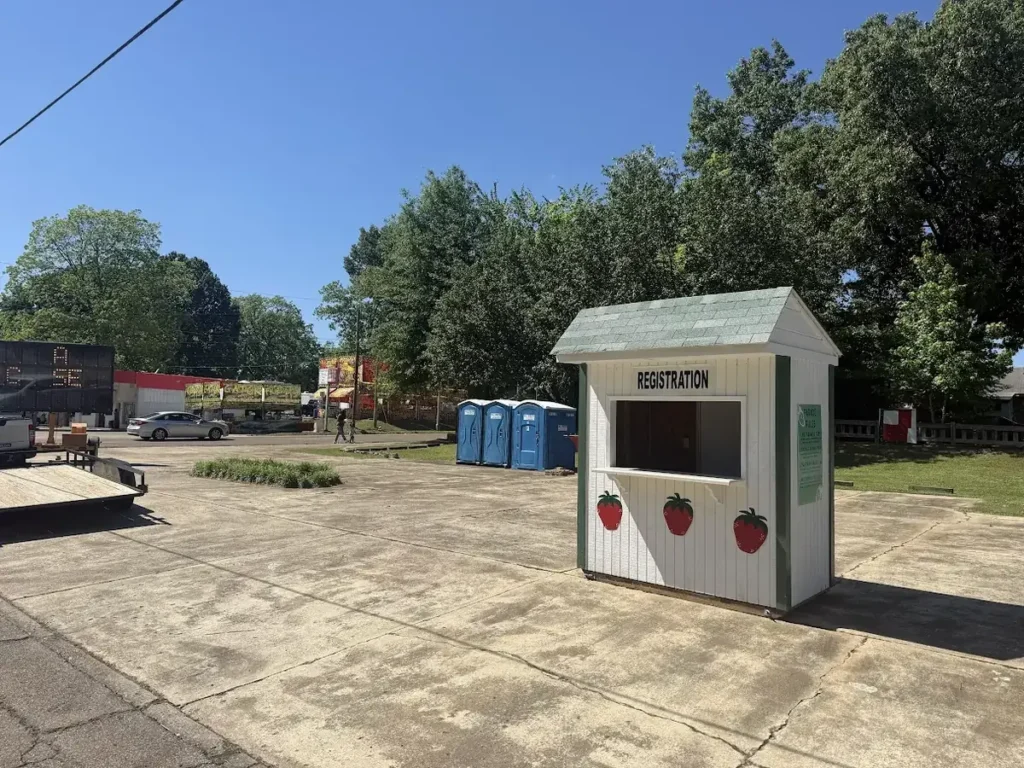 Blue All-Brite portable toilets lined up at a fairground in Jackson TN